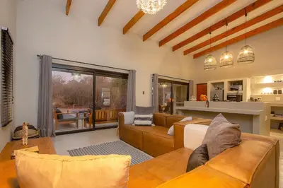 a living room with a couch and a table at Cheetah's Run in Marloth Park