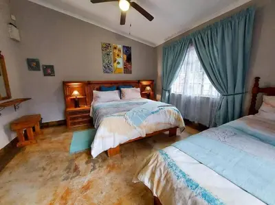 a bedroom with two beds and a window at InnibosRus Self-catering in White River