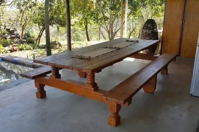 a wooden picnic table and bench in a room at InnibosRus Self-catering in White River
