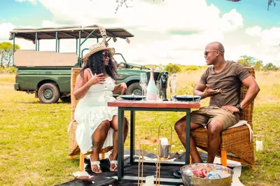 a man and a woman sitting at a table at Mela Luxury Game Lodge in Pretoria