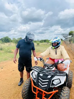 a man and a woman standing next to a quad bike at Mela Luxury Game Lodge in Pretoria