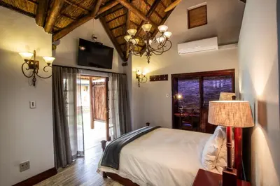 a bedroom with a bed and a television in a room at Lapeng Guest Lodge in Burgersfort