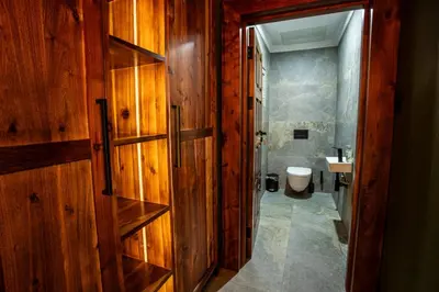 a bathroom with a wooden door and a toilet at Lapeng Guest Lodge in Burgersfort