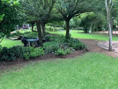 a park with a picnic table and trees and grass at Barnyard Venue in Ermelo