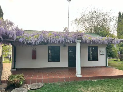 a building with a bunch of purple flowers on it at Barnyard Venue in Ermelo