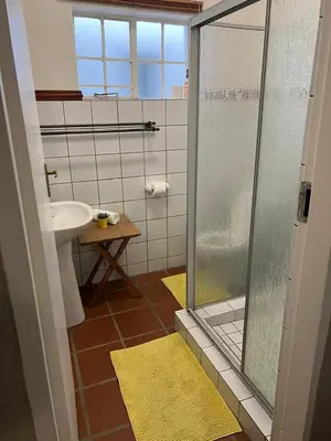 a bathroom with a shower and a sink at Barnyard Venue in Ermelo