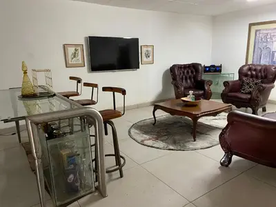 a living room with leather chairs and a tv at Royal Views in Hartbeespoort