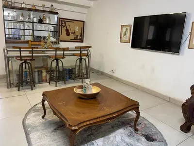 a living room with a coffee table and a flat screen tv at Royal Views in Hartbeespoort
