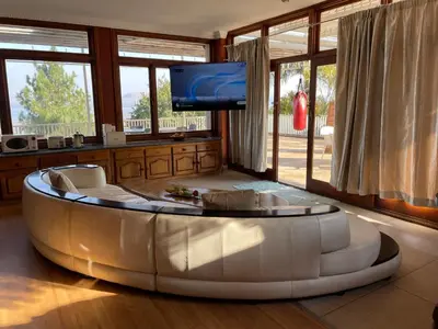 a living room with a large white couch and a tv at Royal Views in Hartbeespoort