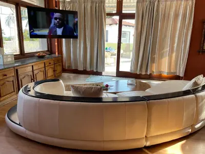 a round coffee table in a living room with a tv at Royal Views in Hartbeespoort