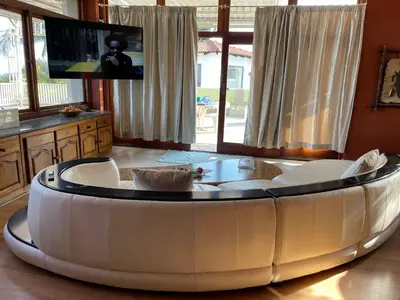a large white round table in a room with a tv at Royal Views in Hartbeespoort