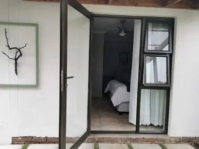 a sliding glass door leading to a bedroom at 19th on Bloekom Guesthouse in Secunda