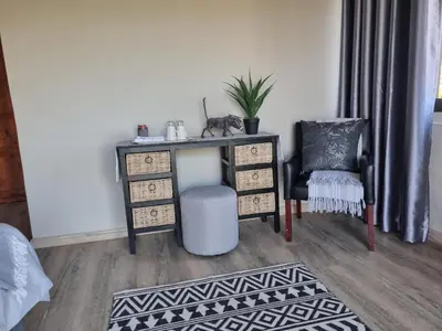 a desk and a chair in a room at Nyani Lodge Dinokeng in Pretoria