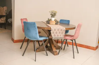 a wooden table with four chairs around it at Senaville Guesthouse in Louis Trichardt