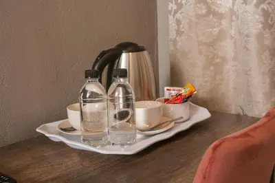 a tray with two bottles and cups on a table at Senaville Guesthouse in Louis Trichardt