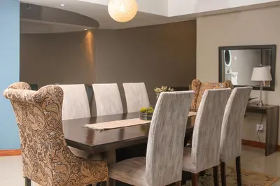 a dining room with a wooden table and chairs at Senaville Guesthouse in Louis Trichardt