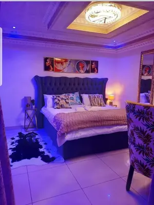 a purple bedroom with a large bed with a purple ceiling at Ko-Porch luxury guest house in Polokwane