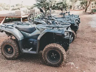 a row of four atvs parked on a dirt road at Thaba eNtle Private Boutique Game Farm in Thabazimbi