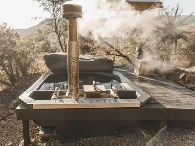 a grill sitting on top of a table with smoke at Thaba eNtle Private Boutique Game Farm in Thabazimbi