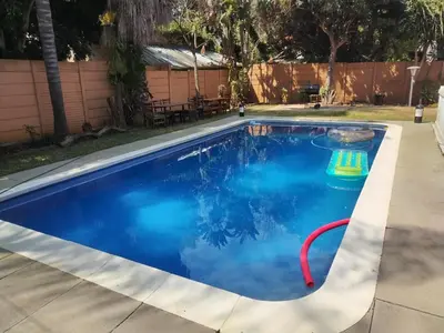 a swimming pool with blue water in a yard at 54 Brecher in Pretoria