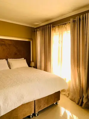 a bedroom with a large bed and a window at Tony Hill Manor House in Shirley
