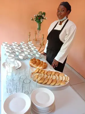 a woman standing in front of a table with plates of food at Tony Hill Manor House in Shirley