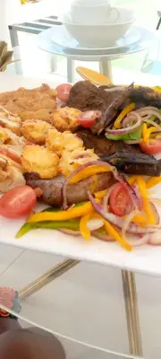a plate of food with meat and vegetables on a table at Tony Hill Manor House in Shirley