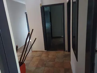 a hallway with a black door and a tile floor at Chasba Airbnb in Hartbeespoort