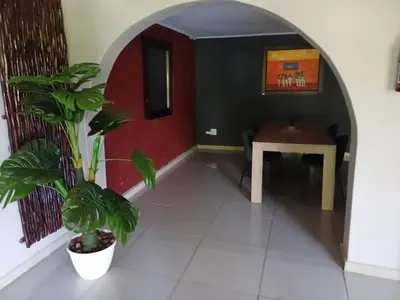 a room with a table and a potted plant at Chasba Airbnb in Hartbeespoort
