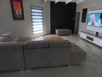 a living room with a couch and a flat screen tv at Chasba Airbnb in Hartbeespoort
