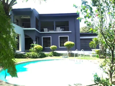 a house with a swimming pool in front of it at Chasba Airbnb in Hartbeespoort