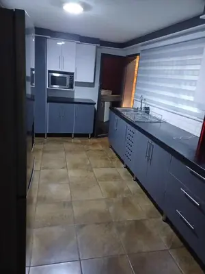 a kitchen with blue cabinets and a sink at Chasba Airbnb in Hartbeespoort