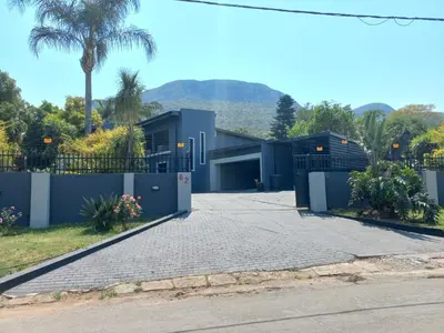 a house with a driveway with a garage at Chasba Airbnb in Hartbeespoort