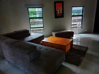 a living room with a couch and a coffee table at Chasba Airbnb in Hartbeespoort