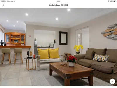 a living room with a couch and a table at Rueby’s Apartment 101 in Dullstroom