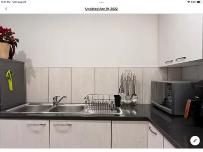 a kitchen with a sink and a microwave at Rueby’s Apartment 101 in Dullstroom