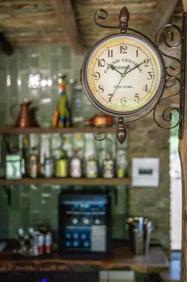a clock hanging from the ceiling of a kitchen at Grace of Africa Boutique Safari Lodge in Marloth Park
