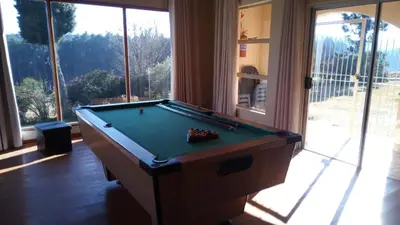 a pool table in a room with a large window at Enon in Haenertsburg