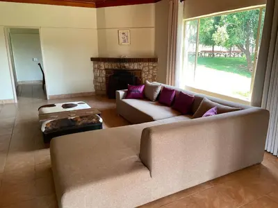 a living room with a couch and a fireplace at Enon in Haenertsburg