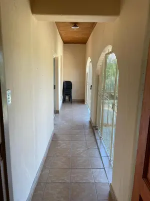 a hallway of a house with a tile floor at Enon in Haenertsburg