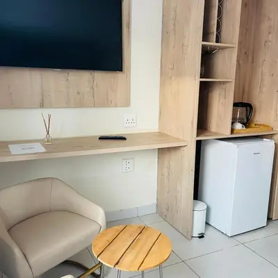 a room with a desk and a chair and a table at Mo'Acress Lifestyle in Temba