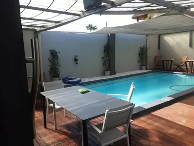 a table and chairs next to a swimming pool at Mo'Acress Lifestyle in Temba
