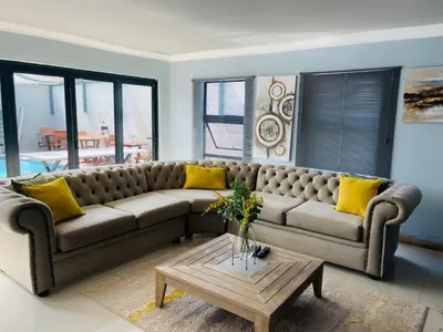 a living room with a couch and a coffee table at Mo'Acress Lifestyle in Temba