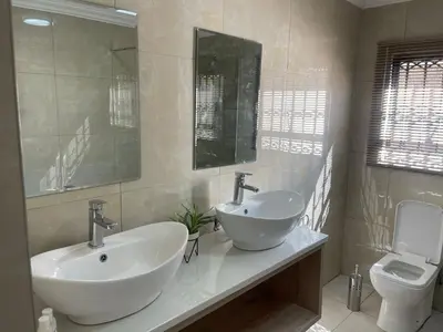 a bathroom with a sink and a toilet at Mo'Acress Lifestyle in Temba