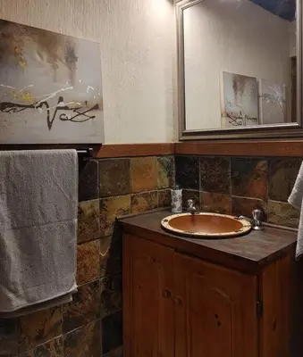 a bathroom with a sink and a mirror at Casa'Roma in Pretoria