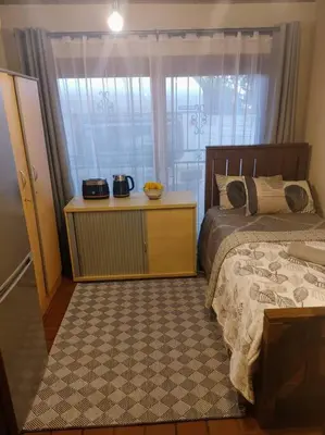 a bedroom with a bed and a window at Casa'Roma in Pretoria