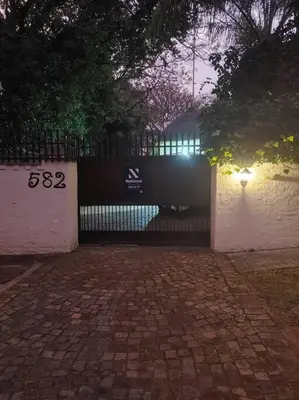 a fence with lights on it next to a brick road at Casa'Roma in Pretoria