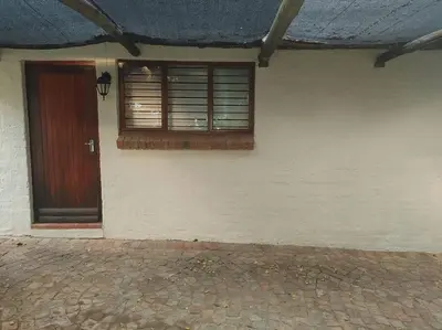 a house with a door and a window and a brick floor at Casa'Roma in Pretoria