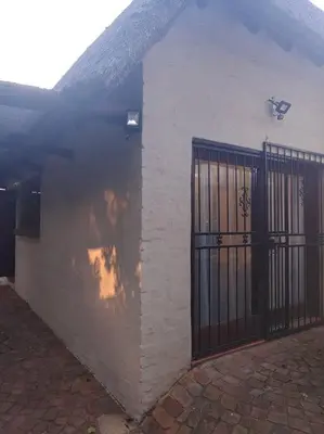 a white building with a gate on the side of it at Casa'Roma in Pretoria