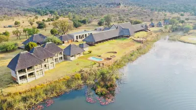 an aerial view of a house next to a river at Waterberg Game Lodge in Bela-Bela